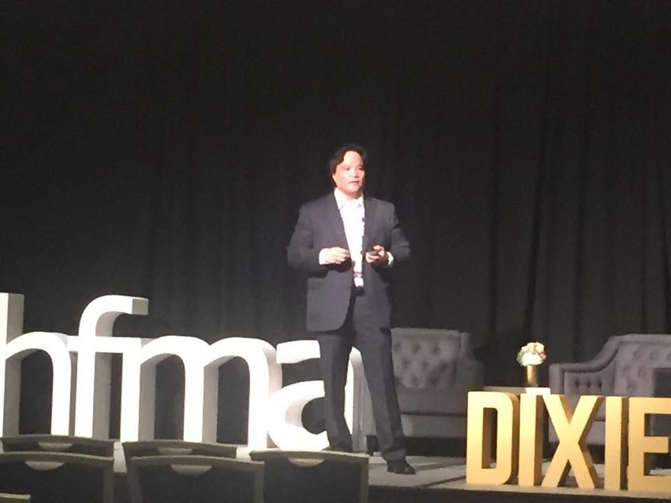 James Paat speaking on stage